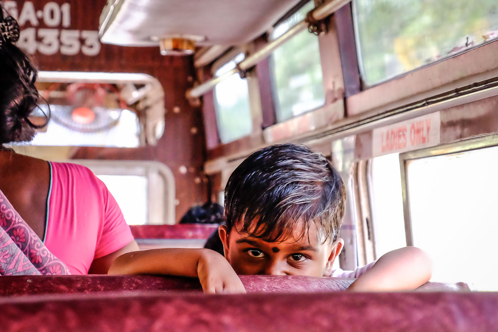 Little Indian boy staring on bus