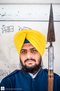 Guards at the Golden temple can be recognised by the yellow turban and the long spear.