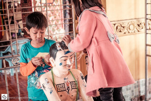 Children decorating a statue in the pagoda