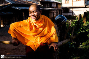 Young monk waiting for his ride
