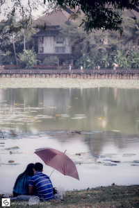 Couple under umbrella in the park