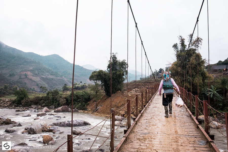 Sa Pa: local womain crossing the wobbly and old bridge